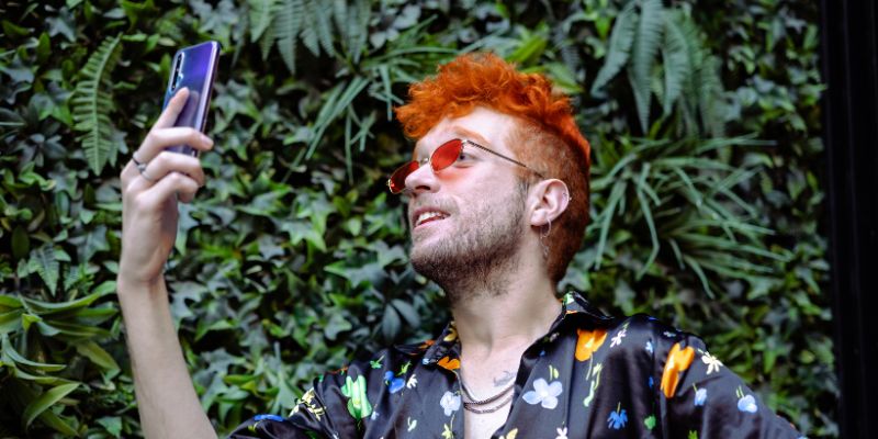 Dos and Don'ts of Pride influencer campaigns man with red hair holding up a phone