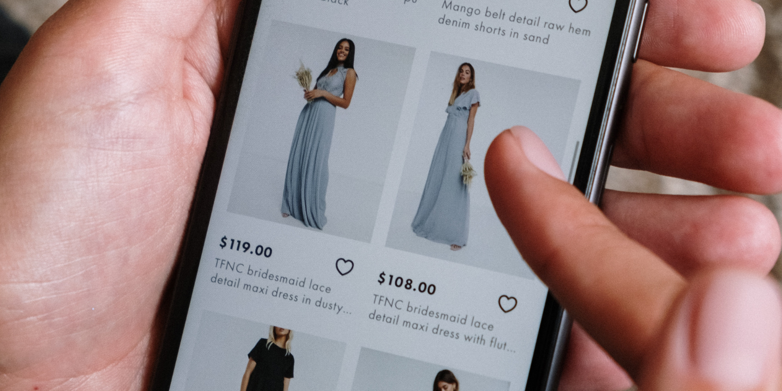 Person scrolling through a shopping site on their phone - social commerce trends