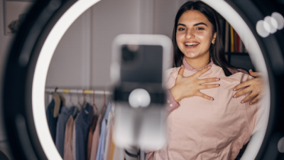 Fashion influencer woman in front of a phone camera and ring light - finding-micro-influencers for your brand